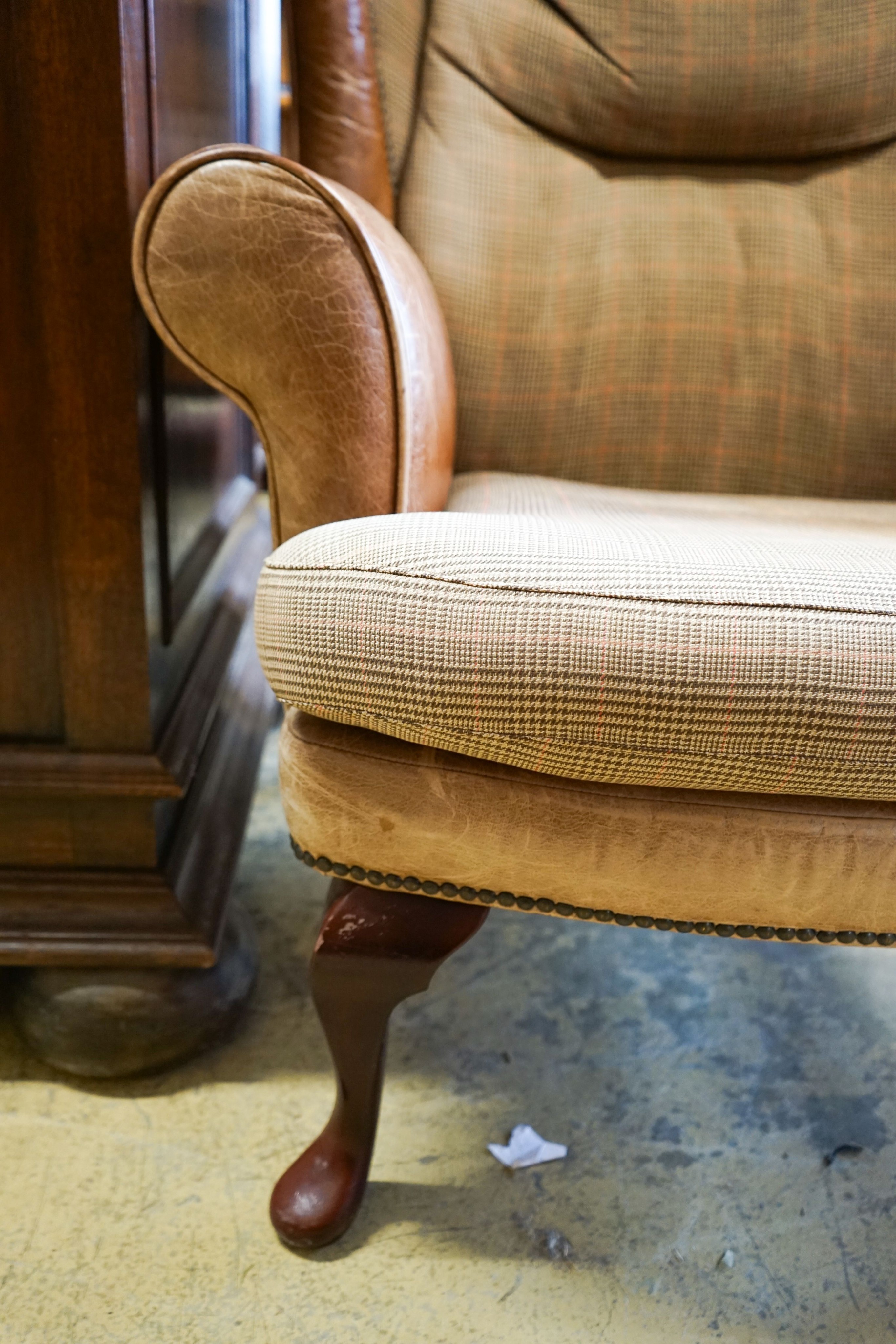 A Victorian style tweed and tan leather wing armchair, width 80cm, depth 84cm, height 98cm